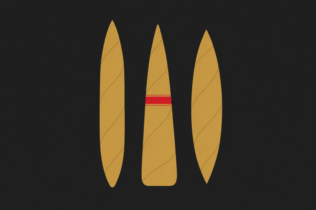 Figurado cigar shapes including torpedo, pyramid and perfecto resting on cedar