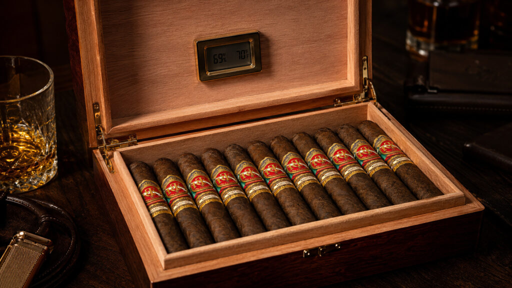 How to store cigars: an open Spanish cedar humidor holding rows of premium cigars