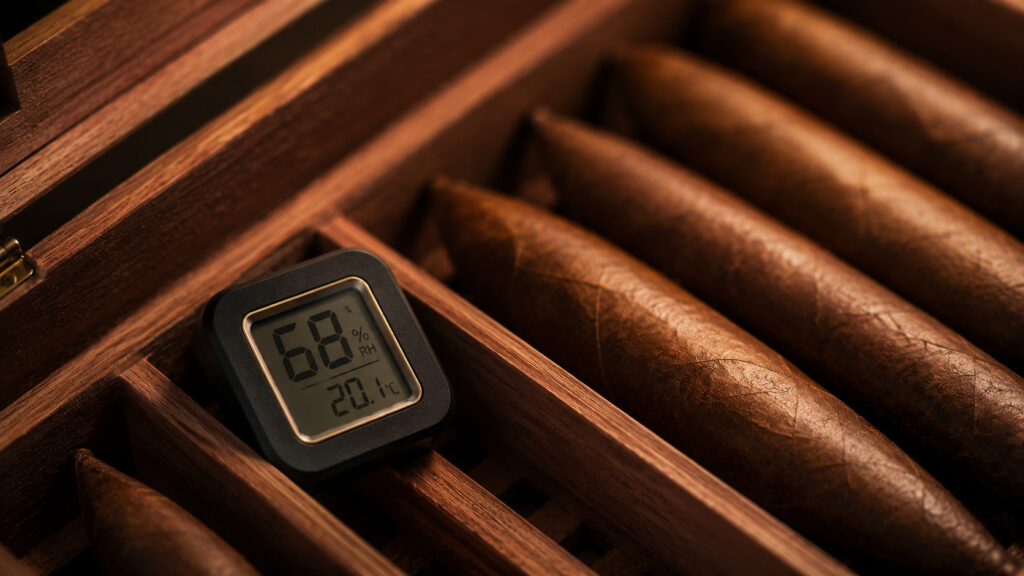 Digital hygrometer showing humidity inside a humidor when learning how to store cigars