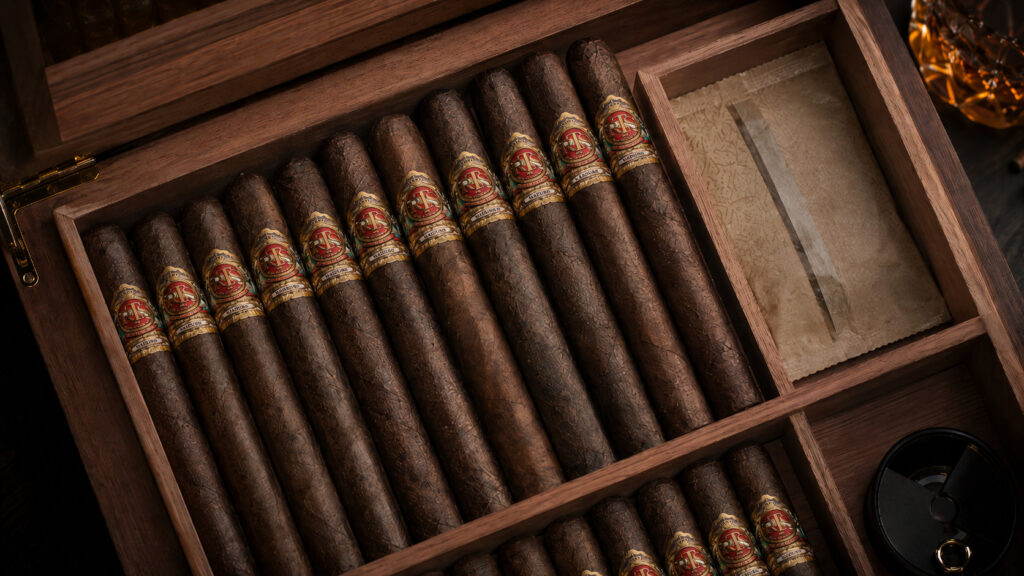 Spanish cedar humidor open with cigars resting inside on cedar dividers