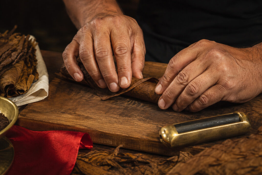 Close view of hands hand-rolling a cigar at a live event in the cuban tradition