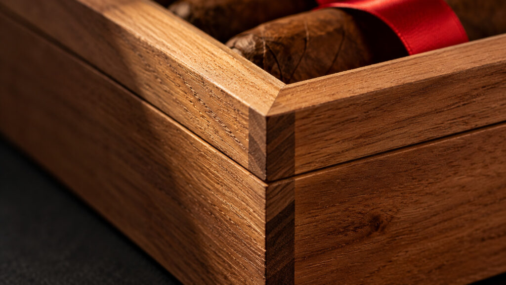 Close crop on the mitred corner and lid fit of a handcrafted cedar cigar box